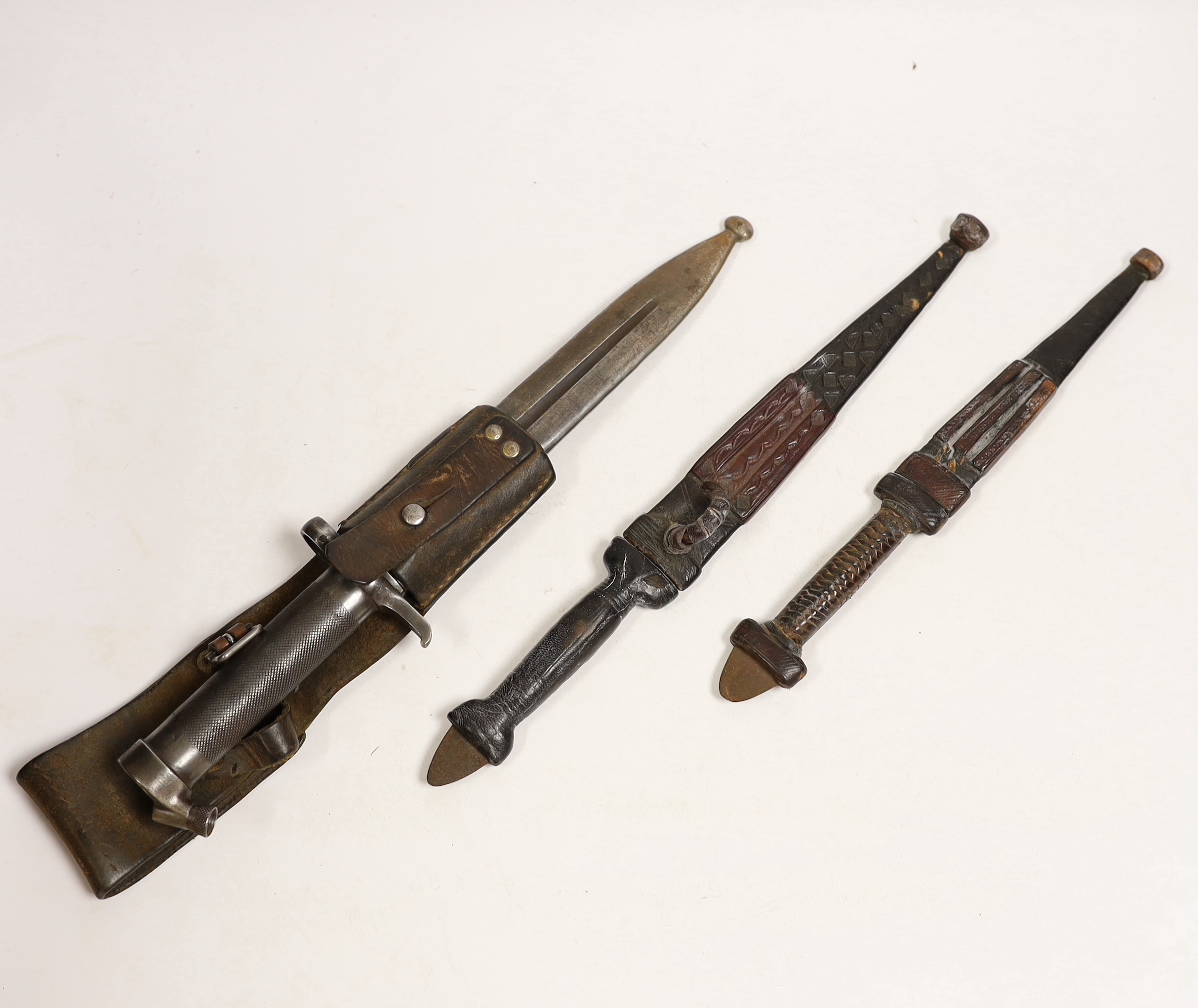 A Swedish Mauser bayonet and two North African daggers